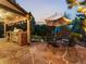 Relaxing outdoor living space featuring a stone patio, built-in grill, and dining set at 7668 S Locust St, Centennial, CO 80112