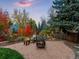 Inviting backyard featuring a fire pit, seating area, and mature landscaping at 7668 S Locust St, Centennial, CO 80112