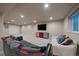 Expansive finished basement with seating, TV area, and versatile living space at 7668 S Locust St, Centennial, CO 80112