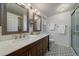 Stylish bathroom with double vanity, modern fixtures, and decorative tile flooring at 7668 S Locust St, Centennial, CO 80112