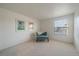 Bright bedroom with plush carpet, featuring a chair and large windows for ample natural light at 7668 S Locust St, Centennial, CO 80112