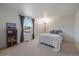 Cozy bedroom features neutral colors, carpet, and large window overlooking the neighborhood at 7668 S Locust St, Centennial, CO 80112