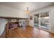 Open living room with a fireplace, exposed beams, and sliding glass doors to outdoor patio at 7668 S Locust St, Centennial, CO 80112