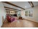Living room features a brick fireplace, exposed beams, and large windows for natural light at 7668 S Locust St, Centennial, CO 80112