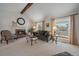 Inviting living room featuring a fireplace, vaulted ceiling with beam, and abundant natural light at 7668 S Locust St, Centennial, CO 80112