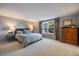 Serene main bedroom with a large window, soft carpeting, and ample space for relaxation at 7668 S Locust St, Centennial, CO 80112