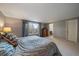 Spacious bedroom with soft carpeting, a large window, and an ensuite bathroom for added convenience at 7668 S Locust St, Centennial, CO 80112