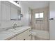 Clean bathroom featuring a vanity with marble countertop and shower with decorative tile at 862 N Uvalda St, Aurora, CO 80011