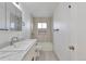 Clean bathroom featuring a vanity with marble countertop and shower with decorative tile at 862 N Uvalda St, Aurora, CO 80011