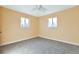 Neutral bedroom with two windows and a ceiling fan at 862 N Uvalda St, Aurora, CO 80011