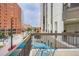 Apartment balcony featuring seating, a beautiful urban view, and city atmosphere at 1625 Larimer St # 1104, Denver, CO 80202