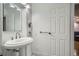Bright, minimalist bathroom with a pedestal sink, clean lines, and white fixtures at 1625 Larimer St # 1104, Denver, CO 80202