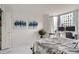 Bright bedroom with workspace, featuring marble floors, a plush bed, and downtown skyline views at 1625 Larimer St # 1104, Denver, CO 80202