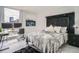 Modern bedroom with a sleek headboard, work station, and city view from the large window at 1625 Larimer St # 1104, Denver, CO 80202