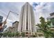 Striking high-rise building featuring modern architecture, balconies, and a vibrant urban setting with green spaces and pedestrian areas at 1625 Larimer St # 1104, Denver, CO 80202