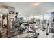 Bright gym featuring large windows, treadmills, and fitness equipment with stunning city views at 1625 Larimer St # 1104, Denver, CO 80202