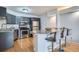 Modern kitchen with stainless steel appliances, gray cabinets, granite countertops, and an island with barstool seating at 1625 Larimer St # 1104, Denver, CO 80202