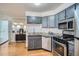 Updated kitchen showcasing stainless steel appliances, granite countertops, and sleek grey cabinetry offering ample storage at 1625 Larimer St # 1104, Denver, CO 80202