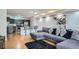 Inviting living space blends a stylish kitchen, bar seating, and a cozy living area with a modern sectional sofa at 1625 Larimer St # 1104, Denver, CO 80202