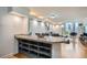 Bright, open-concept living room featuring hardwood floors, city views, a granite bar, and modern decor at 1625 Larimer St # 1104, Denver, CO 80202