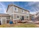 Tan house exterior showcasing a wooden deck with outdoor seating and a grill at 23549 E Ottawa Pl, Aurora, CO 80016