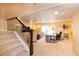 Finished basement featuring carpeted staircase, TV, sewing machine, desk, and seating at 23549 E Ottawa Pl, Aurora, CO 80016