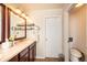 Bathroom featuring double mirrors and a view to the adjacent toilet at 23549 E Ottawa Pl, Aurora, CO 80016