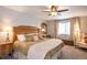 Cozy bedroom with a wooden bed frame, decorative pillows, and a window with natural light at 23549 E Ottawa Pl, Aurora, CO 80016