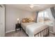 Neutral bedroom featuring a window with gray curtains and a decorative bed at 23549 E Ottawa Pl, Aurora, CO 80016