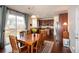 Open dining area with a sliding glass door, adjacent to the kitchen with wood floors and a rug at 23549 E Ottawa Pl, Aurora, CO 80016