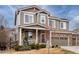 Charming two-story home with stone accents, a covered front porch, and a well-maintained lawn at 23549 E Ottawa Pl, Aurora, CO 80016