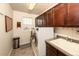 Laundry room with front load washer and dryer, window, cabinets, and utility sink at 23549 E Ottawa Pl, Aurora, CO 80016