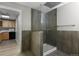 Clean bathroom with a walk-in shower and tiled walls at 3872 S Dallas St # 7-101, Aurora, CO 80014