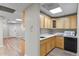 Small kitchen with wood cabinets and appliances at 3872 S Dallas St # 7-101, Aurora, CO 80014