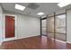 Modern office space with wood-look floors and an exterior door at 3872 S Dallas St # 7-101, Aurora, CO 80014