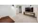 Finished basement with neutral carpet, tv, and modern sconce lighting at 4478 S Acoma St, Englewood, CO 80110