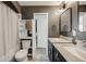 Bathroom featuring double sinks with granite countertops and tile flooring at 4478 S Acoma St, Englewood, CO 80110
