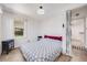 Cozy bedroom with natural light, hardwood floors, and convenient access to an en-suite bathroom at 4478 S Acoma St, Englewood, CO 80110