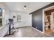 Bright bedroom featuring wood floors, a modern accent wall, and ample natural light at 4478 S Acoma St, Englewood, CO 80110