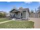 Charming home featuring a covered front porch, well-maintained lawn, and detached two-car garage at 4478 S Acoma St, Englewood, CO 80110