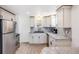 Bright kitchen featuring stainless steel appliances, granite countertops, and ample cabinet space at 4478 S Acoma St, Englewood, CO 80110