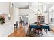 Dining area with hardwood floors, a view of the foyer, and an adjacent kitchen at 1011 S Valentia St # 1, Denver, CO 80247