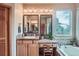 Bright bathroom featuring double vanity, tub, and natural light from large windows at 31190 Cinnamonwood, Evergreen, CO 80439