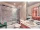 Full bathroom featuring a tub/shower combo, wood cabinets, and a tiled shower surround at 31190 Cinnamonwood, Evergreen, CO 80439