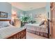 Bright bedroom with twin beds, light blue walls, and natural light from the corner windows at 31190 Cinnamonwood, Evergreen, CO 80439