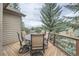 Outdoor deck with table and chairs surrounded by trees and featuring mountain views at 31190 Cinnamonwood, Evergreen, CO 80439
