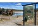 Scenic view of the lake, boathouse, and a sign about the Evergreen Lake Trail at 31190 Cinnamonwood, Evergreen, CO 80439