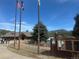 Exterior of the log cabin featuring the lake, flags, and walking path at 31190 Cinnamonwood, Evergreen, CO 80439