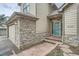 Charming front entrance with stone accents, a teal door, and well-maintained landscaping at 31190 Cinnamonwood, Evergreen, CO 80439
