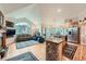 Open-concept kitchen and living area featuring modern appliances, a cozy fireplace, and picturesque views at 31190 Cinnamonwood, Evergreen, CO 80439